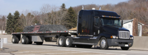 Flatbed Truck driving up the highway