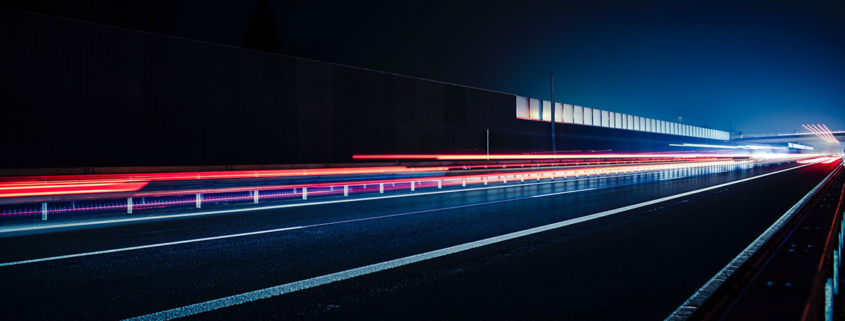 Red vehicle lights streaming across a freeway