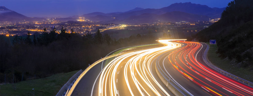 Highway with many car light trails at night