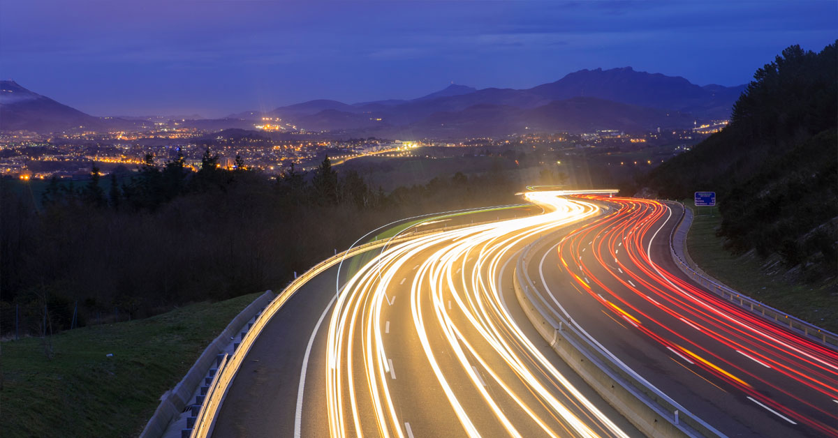 Highway with many car light trails at night